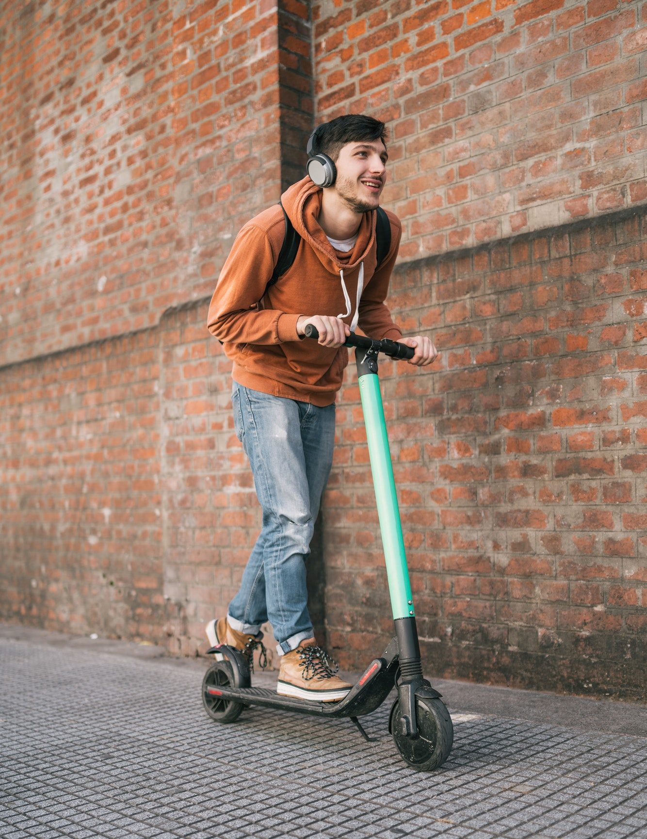 young-man-driving-electric-scooter--e1632797455870.jpg